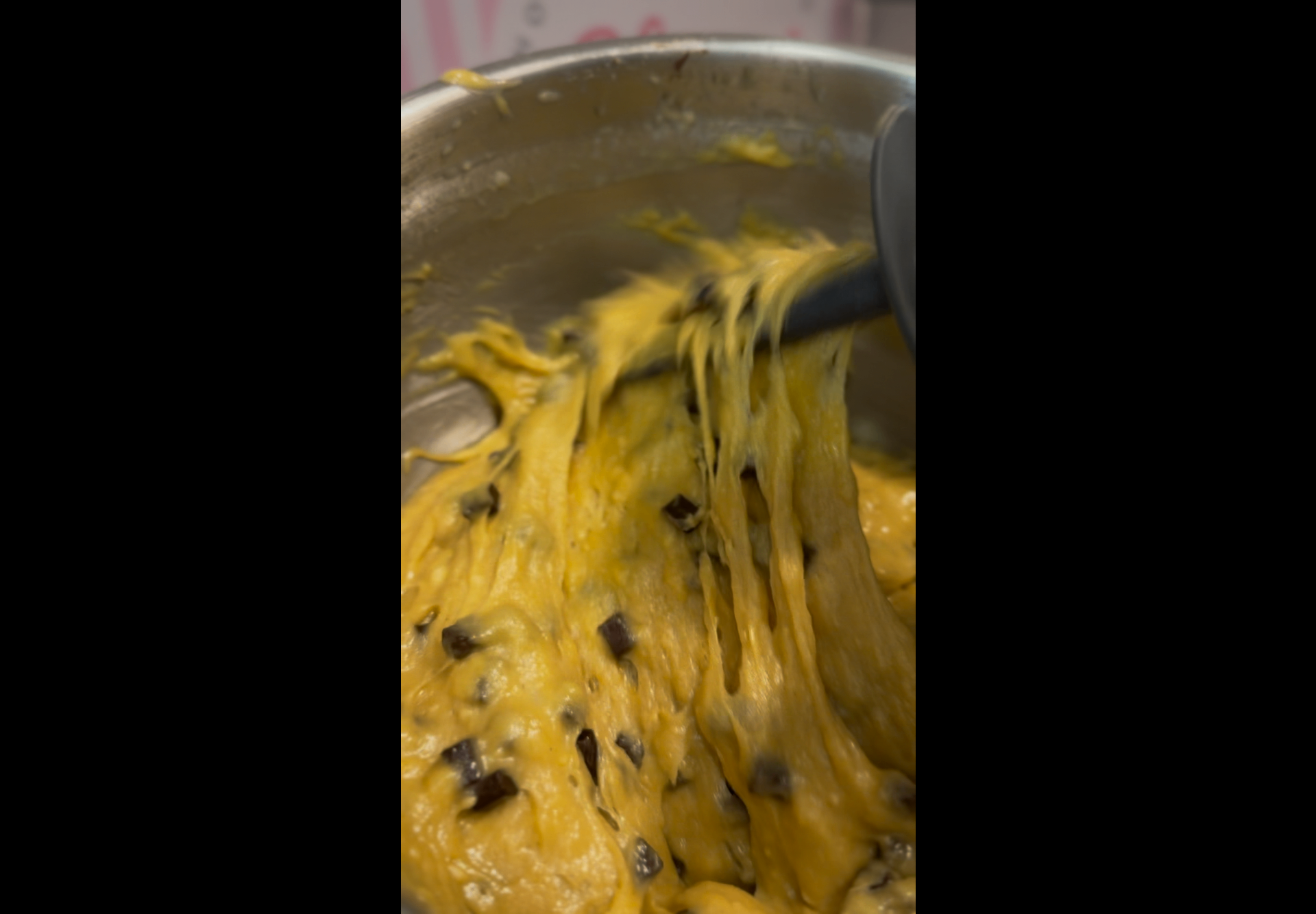 Mixing cookie dough with chocolate chunks
